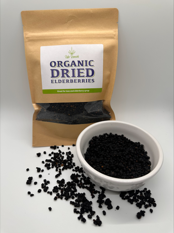 A bowl of dried elderberries next to an organic bag.