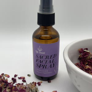 A bottle of facial spray next to some dried flowers.