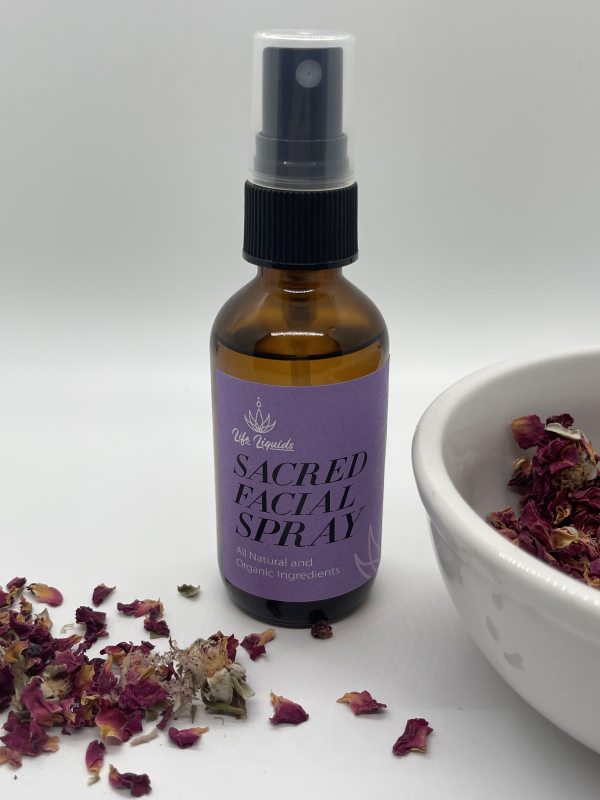 A bottle of facial spray next to some dried flowers.