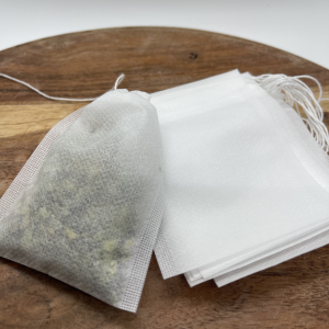 A wooden table with tea bags on it