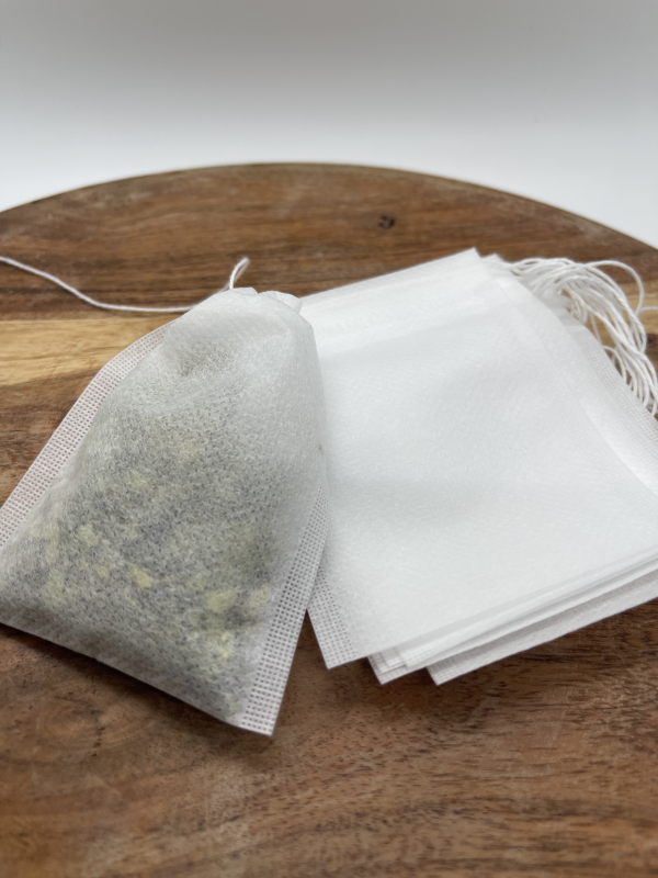 A wooden table with tea bags on it