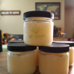 A stack of three jars with cbd products in them.